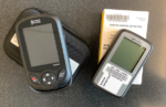 Photo of two handheld pieces of equipment. On the left is a black thermal imaging camera; on the right is a gray radon detector.